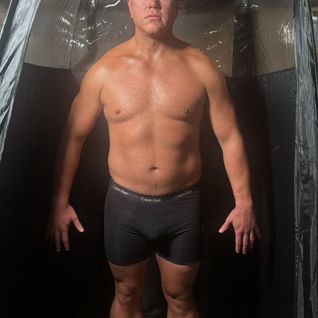 Male client immediately after custom spray tan application by Sunny Daze Sunless in Lawrence, Kansas