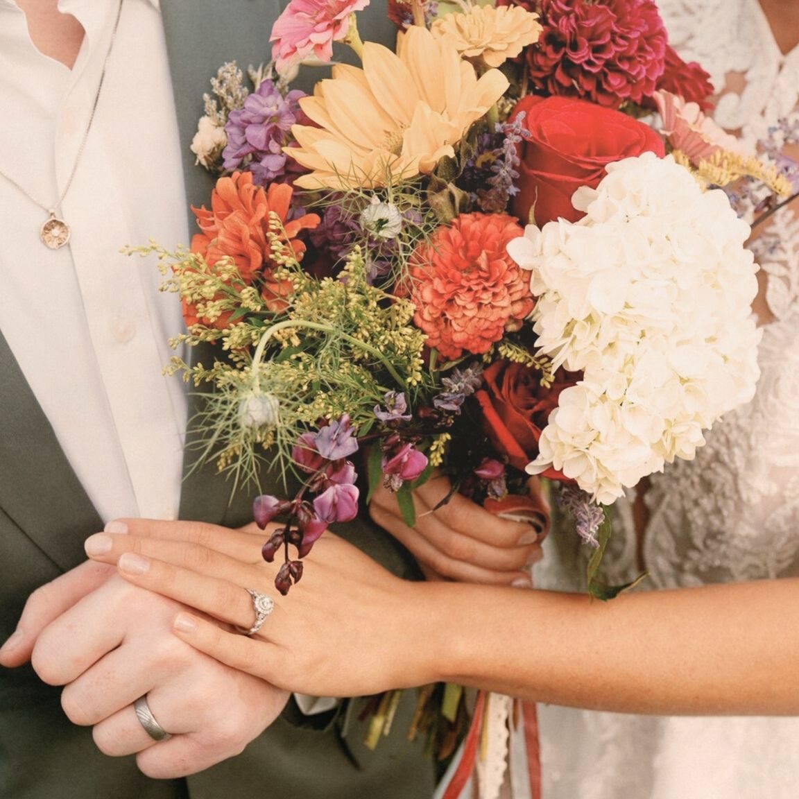 Close-up of bride’s hands showing seamless spray tan blend while holding bridal bouquet - Sunny Daze Sunless