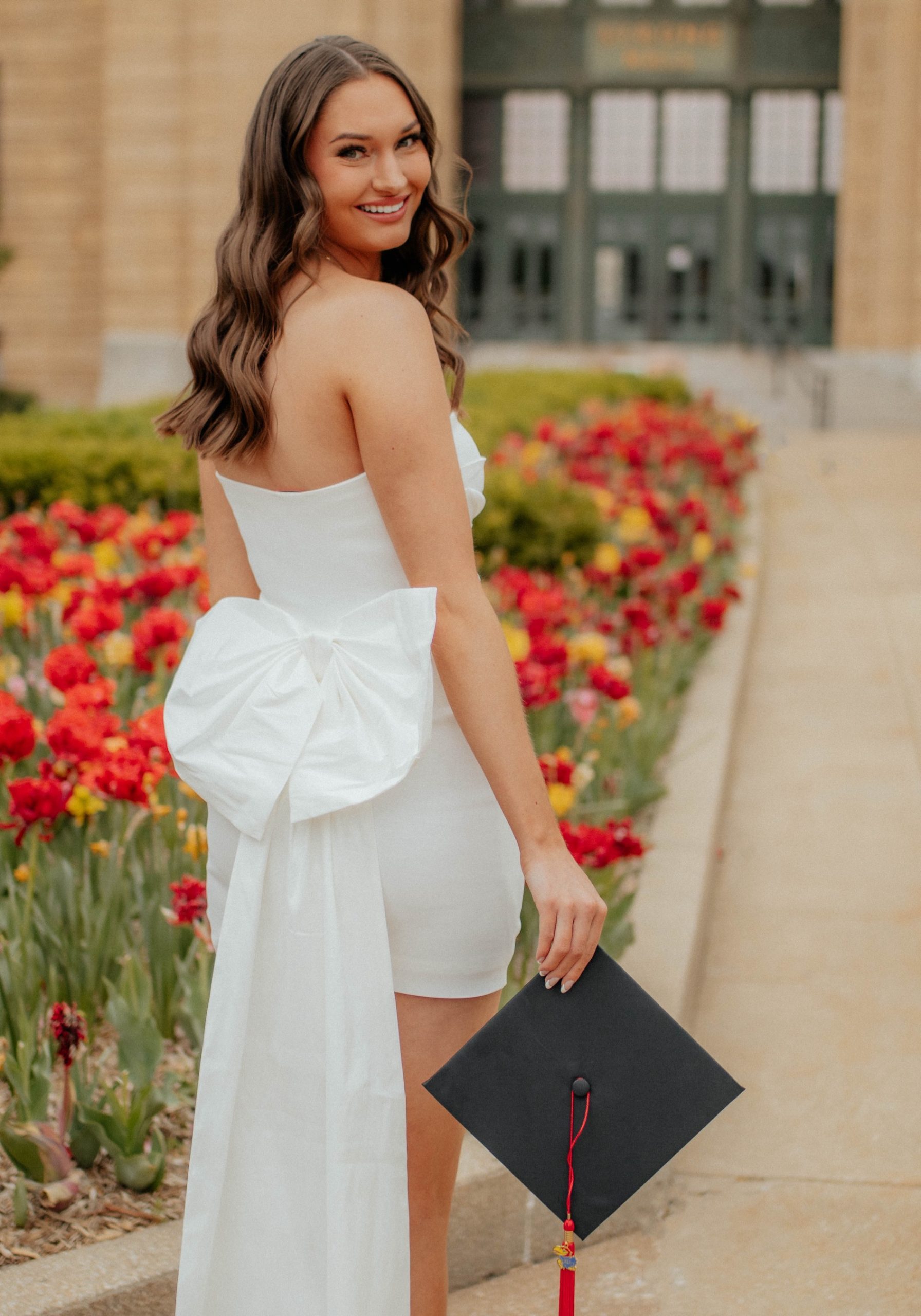 College graduate with custom spray tan by Sunny Daze Sunless for graduation photos in Lawrence, Kansas