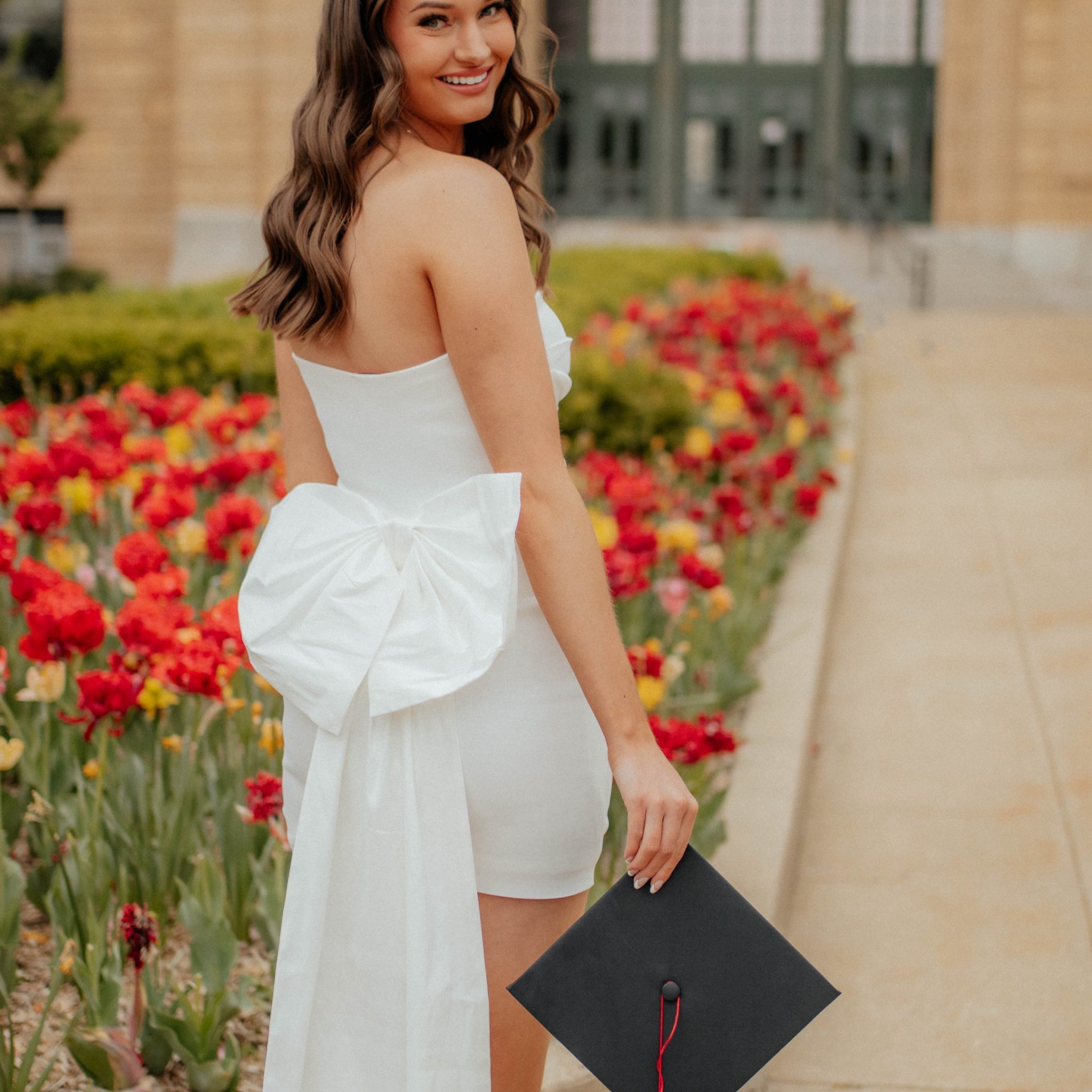 College graduate with custom spray tan by Sunny Daze Sunless for graduation photos in Lawrence, Kansas