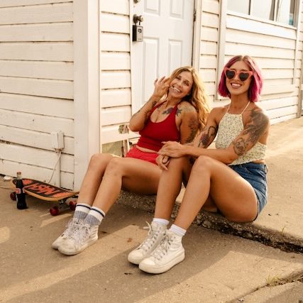 Two models with custom spray tans by Sunny Daze Sunless during brand photoshoot in Lawrence, Kansas