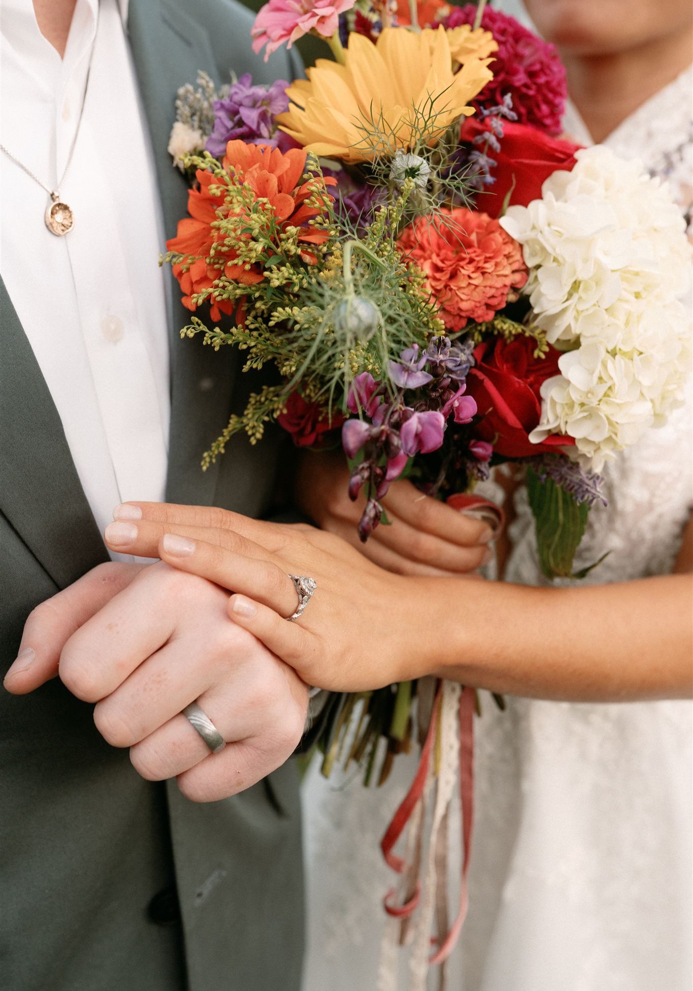 Close-up of a bride's hands and wedding ring with a flawless, golden spray tan by Sunny Daze Sunless.