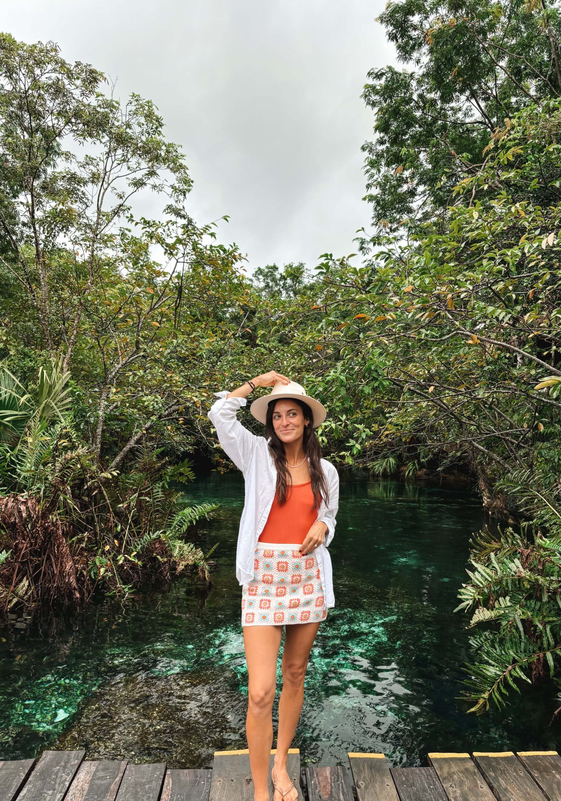 Woman with natural sun-kissed spray tan on tropical vacation — mobile spray tan results by Sunny Daze Sunless, Lawrence KS